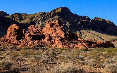 Red rock formation set against a dark mountain in Valley of Fire SP