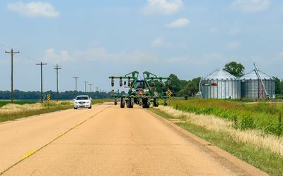 Farm equipment taking up a lot of space on a Mississippi road