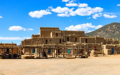 Main building under blue skies in Taos Pueblo