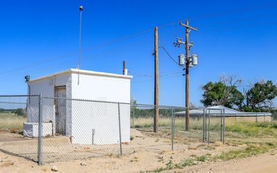 Well House with Water Reservoir in the background in Amache NHS