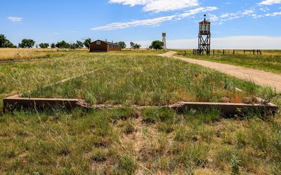 Block 12 G foundation with barracks, Water Tank Tower and Guard Tower along the perimeter of Amache NHS