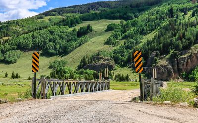 Remaining bridge over the Eagle River with the Climbing Wall in the distance in Camp Hale NM