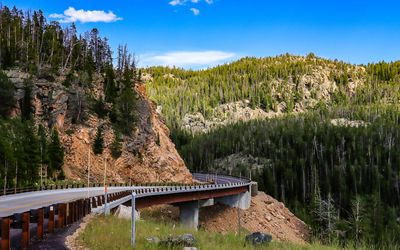The road curves around a hillside along the Beartooth Highway
