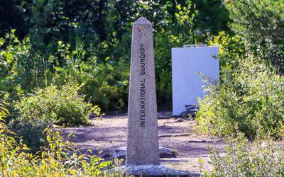 Looking directly down the border as International Boundary and 1908 Treaty markers align in Waterton Lakes NP