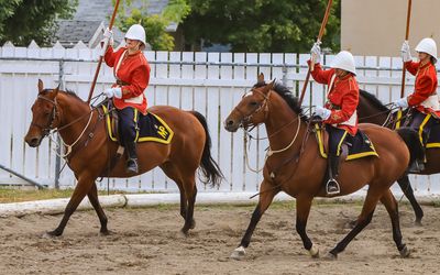 NWMP ride in the arena in Fort Macleod