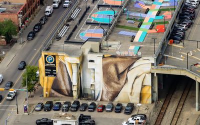 A mural on the side of a building as seen from the Calgary Tower in Calgary