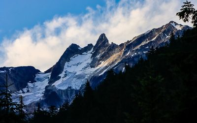 View of glaciers shaded by mountain peaks in Glacier NP