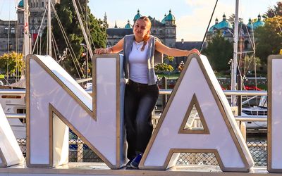 A Canada fan posing with the Canada sign in Victoria BC