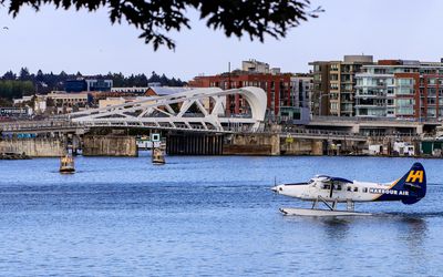 Tourist float plane takes off in front of the Johnson Street Bridge in Victoria BC