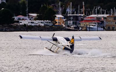 Tourist float plane landing on Victoria Harbor in Victoria BC