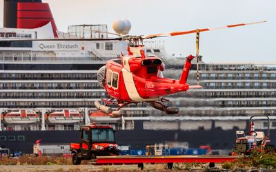 Canadian helicopter taking off in front of the Queen Elizabeth as seen on the Whale Watching Tour