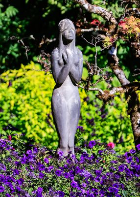 Statue among the flowers of the Sunken Garden in Butchart Gardens