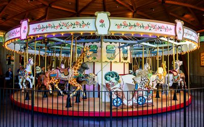 The Rose Carousel with hand-carved wooden animals in Butchart Gardens