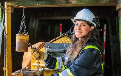 Guide rings the bell to begin the descent into the mine at the Britannia Mine National Historic Site