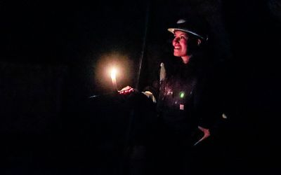 Guide using only candlelight at the Britannia Mine National Historic Site