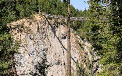 People cross the 492-foot-long suspension bridge, 426 feet above the canyon at Golden Skybridge