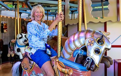 Mindy rides a horse at the Rose Carousel in Butchart Gardens