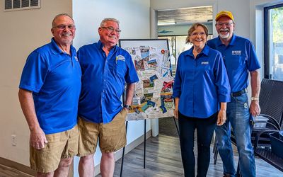 Wagonmasters Andy and George and Tailgunners Ann and Doug around the Activities Board