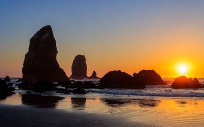 The sun setting on the Needles on Cannon Beach