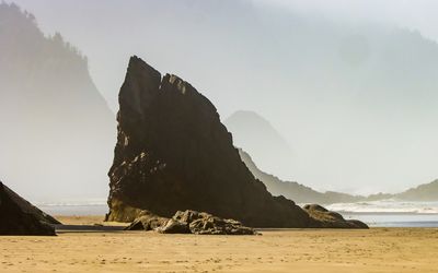 Volcanic rock towers over the beach on the Oregon Coast
