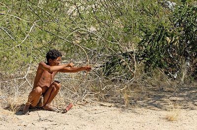 One of the San people explaining some of the way they hunt