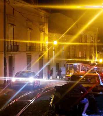 What happens when a car meets an electrico & car must back up a couple blocks!