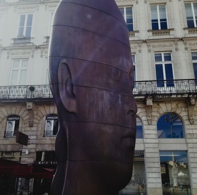 Head statue near Place de la Comedie was interesting.  Looked different in different angles. 