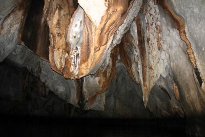 The cave was dark and quiet inside.  The boat pilot would shine his flashlight on the rocks.
