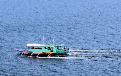 A fancy bangka sails along with us.