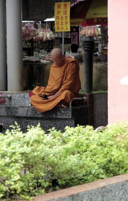 Monk with cell phone in Bugis