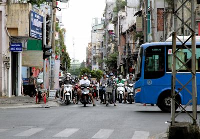 Only a bus or red light stops traffic at an intersection here in Vietnam