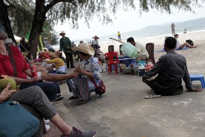 Activity at beachfront included women offering massages & a man quietly looking for donations.