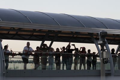 Visitors waving at us while someone on a loudspeaker cheered our passage.