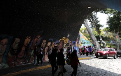 Underpass murals with walkers