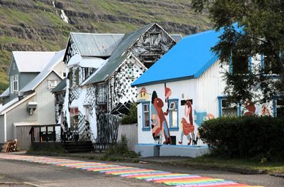Seydisfjordur has colorful building & a rainbow road. 