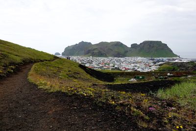 View of Eldfell lava path, houses & another island on the way toward the top of Eldfell