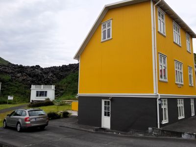 The little white house is Blatinder House - a house almost buried in lava. 