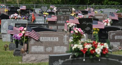 Flags mark the headstones of veterans, Memorial Day, 2024