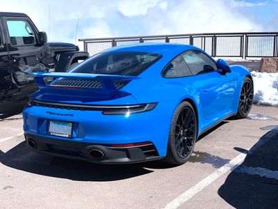 From Illinois, a 2023 Porsche 911 Carrera GTS (992), in Shark Blue with optional wing, at the summit of Pikes Peak. (9120)