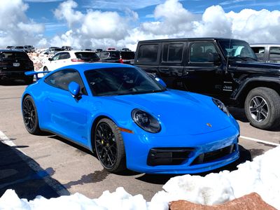 From Illinois, a 2023 Porsche 911 Carrera GTS (992), in Shark Blue with optional wing, at the summit of Pikes Peak. (9118)