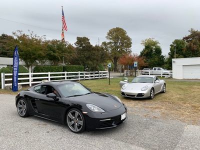 2017 Porsche 718 Cayman (982), foreground, and 2009 Cayman (987.2) (4121)