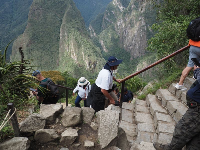 Hiking Machu Picchu high above. Many stairs to climb