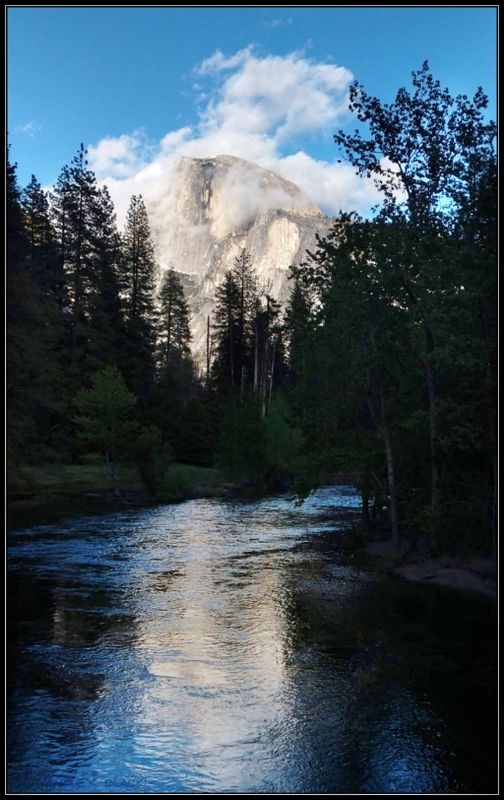 CLOUDS FLOATING BY HALF DOME 