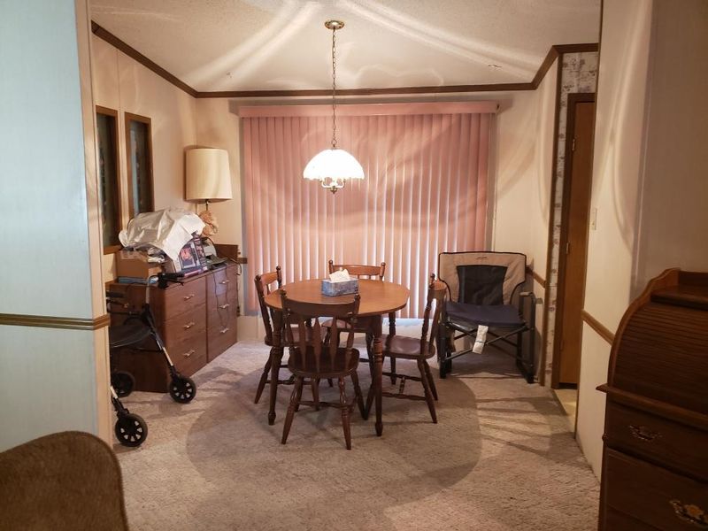 Dining room is next to foyer, with windows looking into foyer.