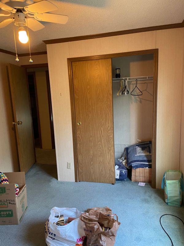 Third bedroom closet and door to the third bedroom. Both back bedrooms do have ceiling fans, too.
