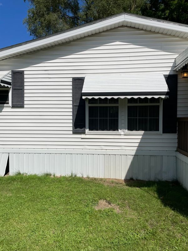 Same side, kitchen window on left, dining room window ahead, deck barely visible on right.
