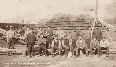 Closeup - Coal pile near Edsbyn, group of men, approx 1910