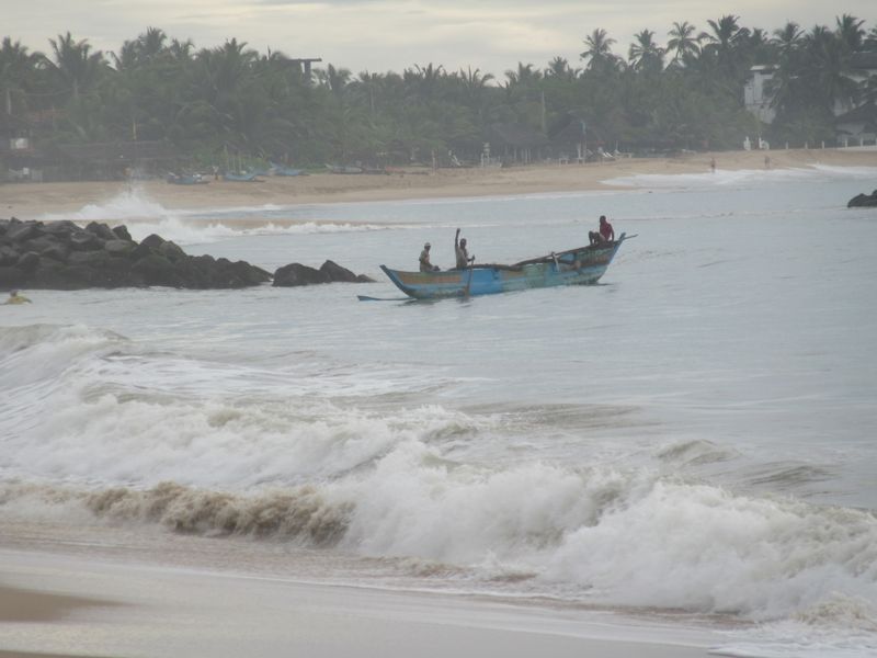 Dropping off a fisherman, who swims back to shore