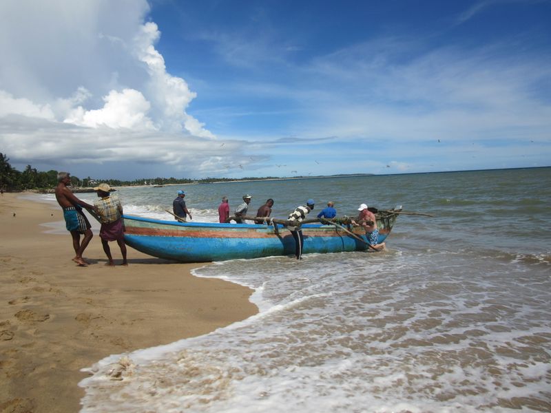 Pulling the heavy wooden boats up onto the beach