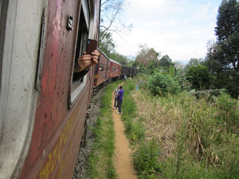 People walk along the train tracks...